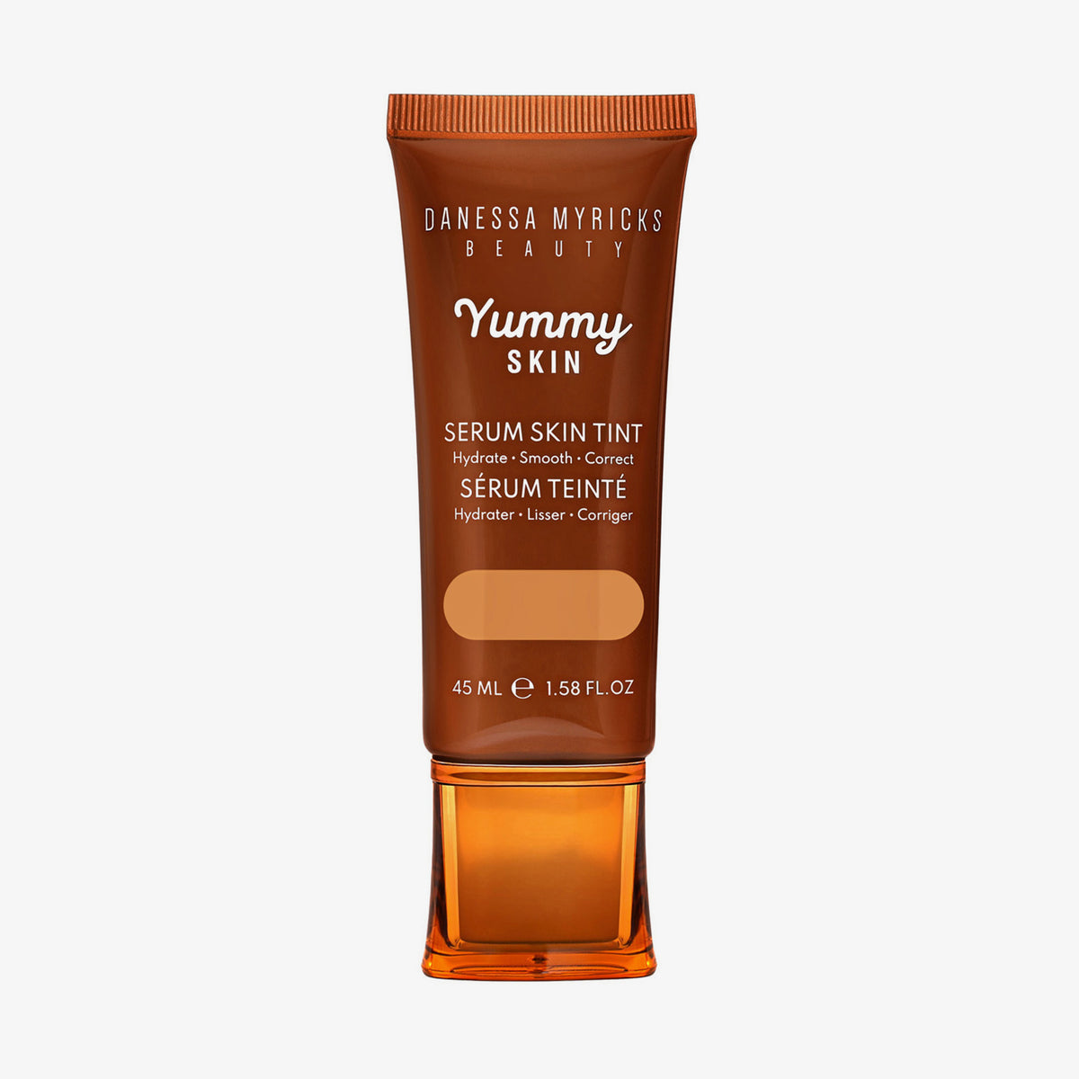 Bronzefarbene Tube der Yummy Skin Serum Tint 6 mit Sichtfenster zum warmem dunkelbeigem Produktinhalt.