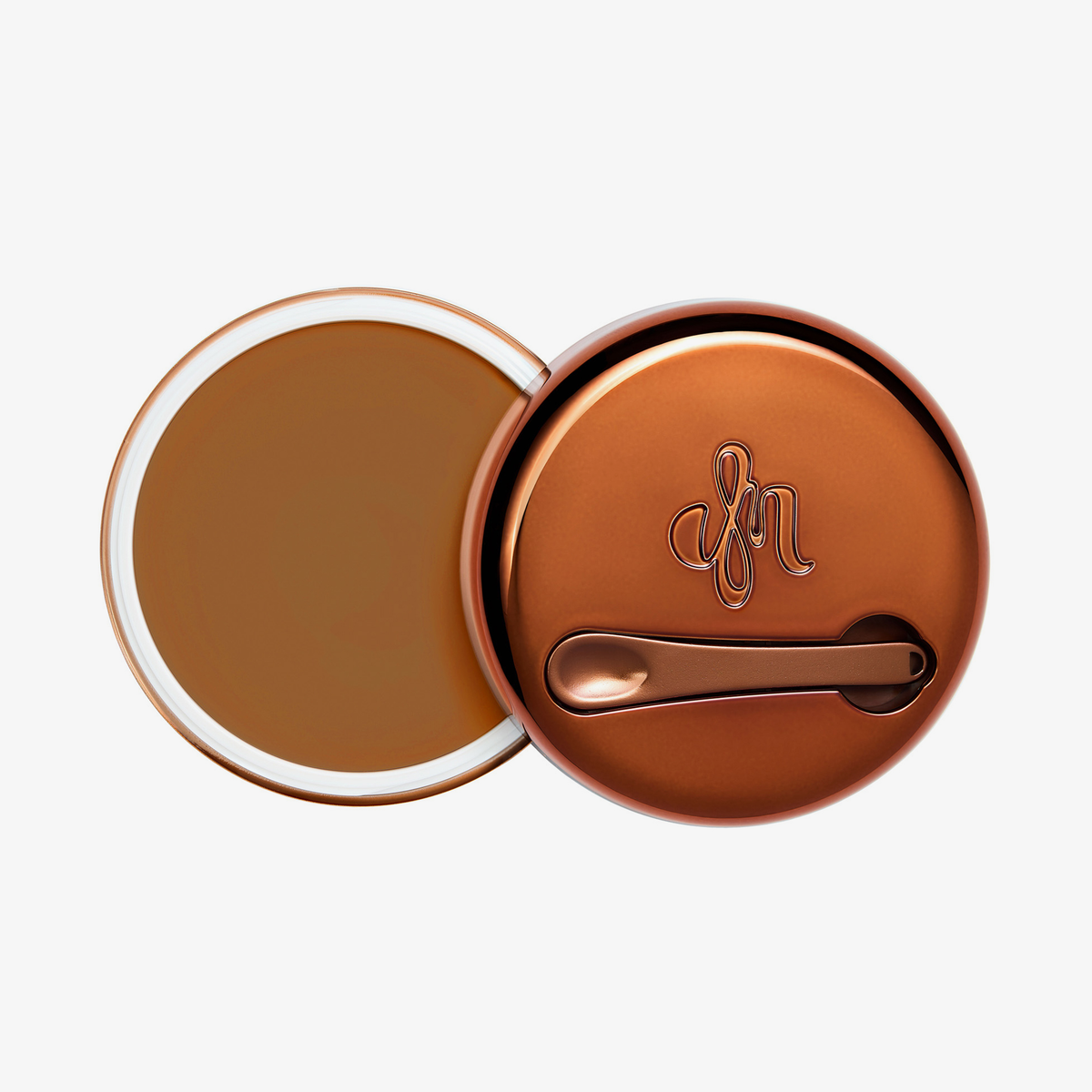Runder geöffneter Behälter Yummy Skin Blurring Balm Shade 7 mit bronzefarbenem Deckel und kleinem Applikator.