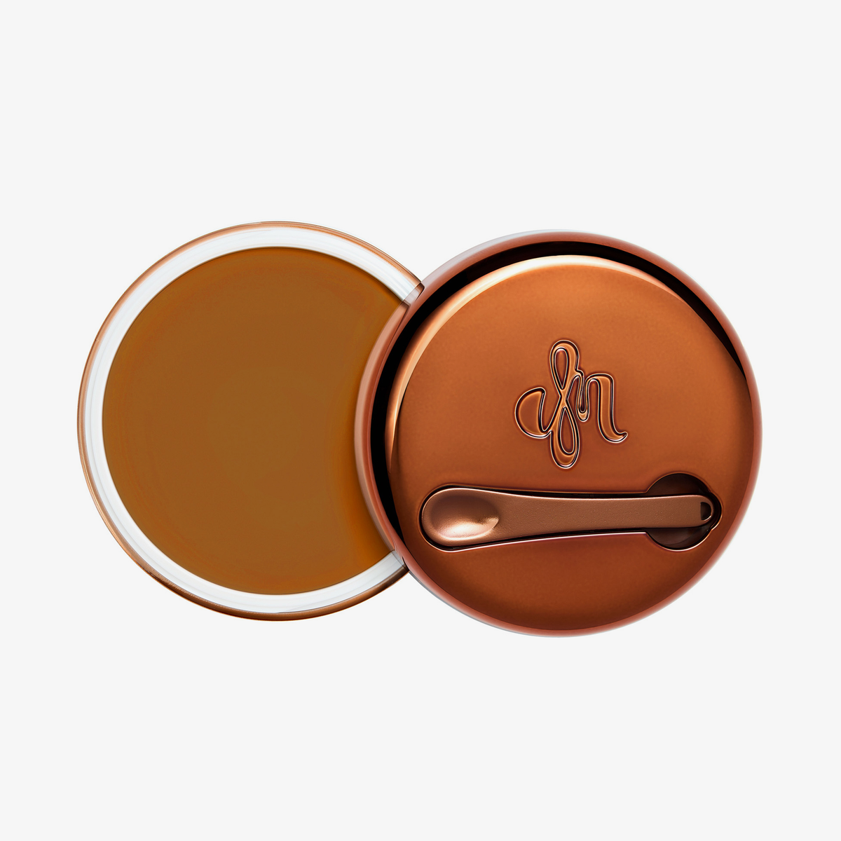 Runder geöffneter Behälter Yummy Skin Blurring Balm Shade 8 mit bronzefarbenem Deckel und kleinem Applikator.