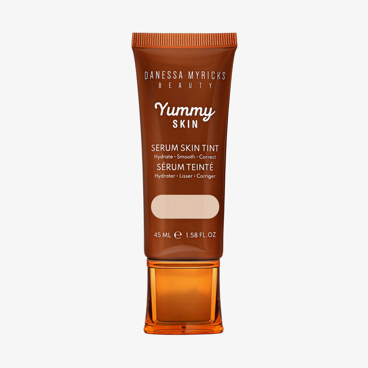 Bronzefarbene Tube der Yummy Skin Serum Foundation 1.5 mit Sichtfenster zum beigen Produktinhalt.