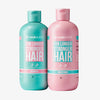 Zwei Flaschen des Shampoo & Conditioner Duo Packs For Longer Stronger Hair von Hairburst, in türkisfarbener und rosa Verpackung.
