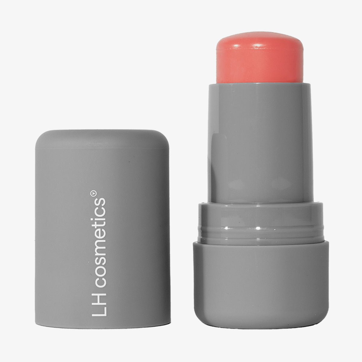 Ein geöffneter grauer Drehstift mit herausgedrehtem korallrosa Artistick Blush Sketch vor weißem Hintergrund