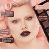 Eine Frau mit hellem Teint und rosa Haaren trägt dramatisches Make-up aus der Groundwork Palette – Blooming Romance in den Farbtönen Allure, Crush, Lovesick, Smitten und Evermore.