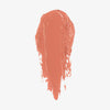 Ein pfirsichfarbener Farbstreifen des Blush Stick - 2-in-1 Creme Rouge mit Pinsel in der Farbe Coral.