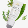 Biotin Conditioner Tube mit Aloe Vera und Rosmarinzweigen auf weißem Hintergrund.