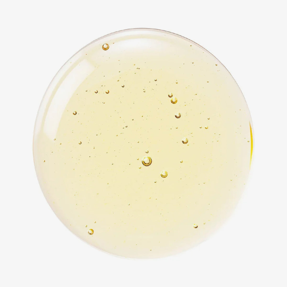 Ein runder, gelblich-klarer Tropfen Mixsoon Bean Essence auf weißem Hintergrund abgebildet.