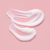 Die MIZON Snail Repair Eye Cream wird mit sanften, streichenden Bewegungen auf einen hellrosa Hintergrund aufgetragen.