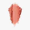 Blush-Puder in der Farbe paradise, als kräftiger Farbstrich mit krümeligen, unregelmäßigen Rändern auf weißem Hintergrund.