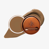 Runde geöffnete bronzefarbene Dose des Yummy Skin Blurring Balm Powder vor einem Farbstreifen der Shade 6.