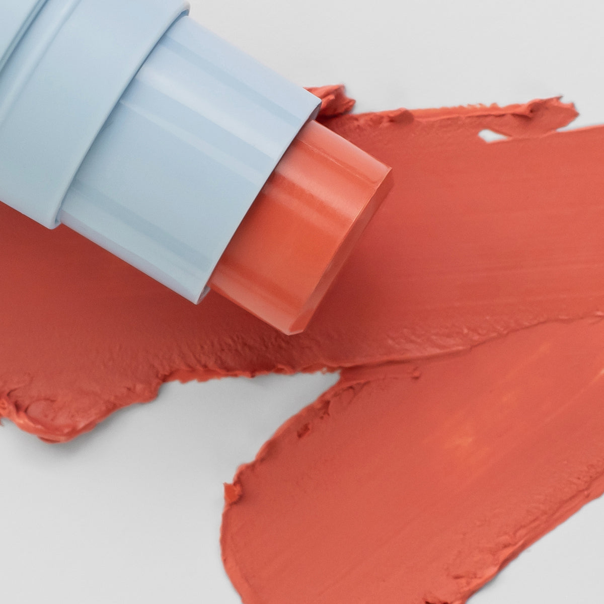 Nahaufnahme des Blush Stick - 2-in-1
Creme Rouge mit Pinsel in der Farbe Love neben cremigem Farbmuster.
