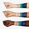 Drei Arme mit unterschiedlichen Hauttönen zeigen Farbmuster der Bad Side Zodiac WATER Eyeshadow Palette, mit Namen beschriftet ist.