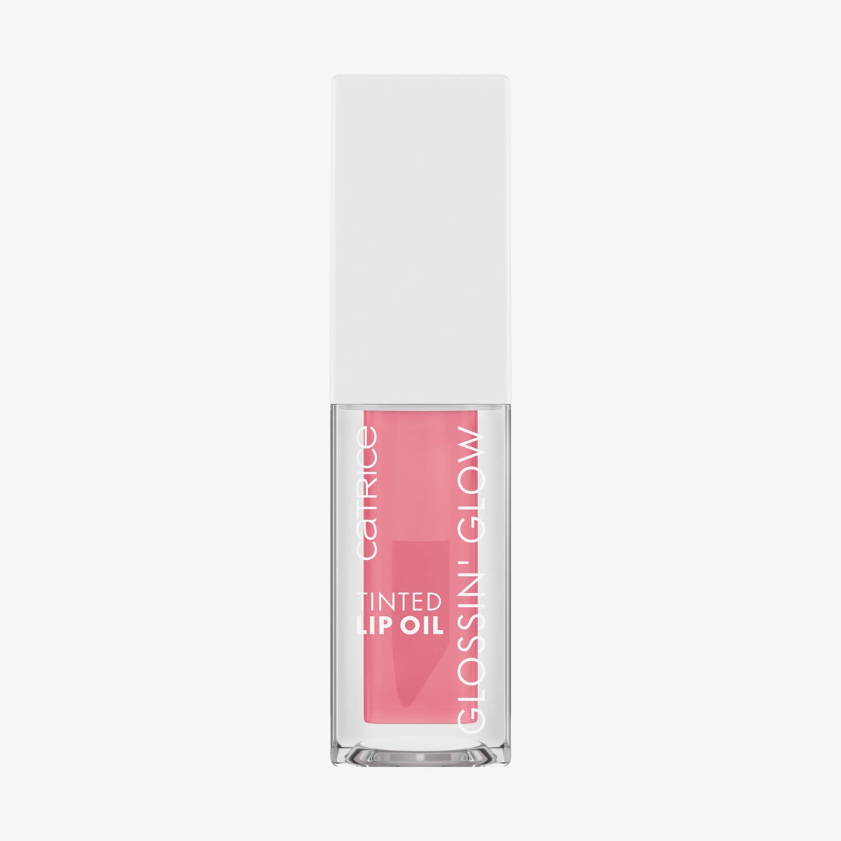 Transparente Flasche mit rosa Glossin‘ Glow Tinted Lip Oil von Catrice und weißem Deckel vor weißem Hintergrund.
