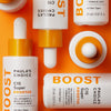 C15 Super Booster-Flaschen und -Tropfer von Paula’s Choice auf orangefarbenem Hintergrund.