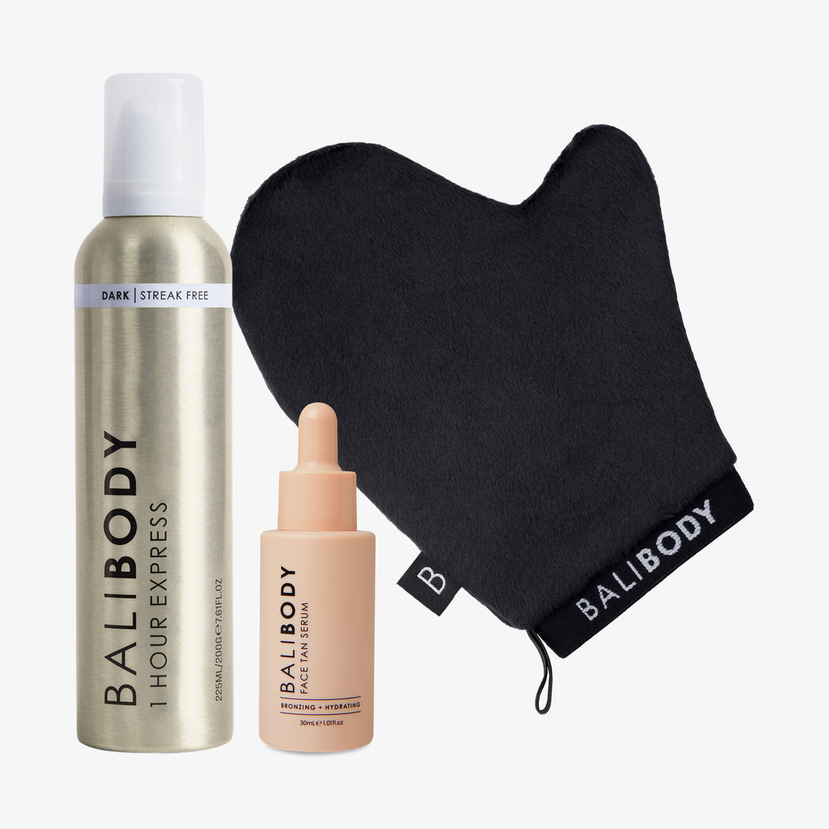 Luxe Tan Mitt, eine Tropfflasche Face Tan Serum und eine goldene Flasche 1 Hour Express vor weißem Hintergrund