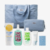 PURISH Summer Bag 2025 – Basic Routine: Blaues Tragetaschen-Set mit Bondi Sands SPF50+ Lotion, The Fox Tan, Sonnencreme, Beutel und Karte.
