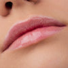 Nahaufnahme der Lippen einer Person mit heller Haut mit dem Glossin‘ Glow Tinted Lip Oil 030.