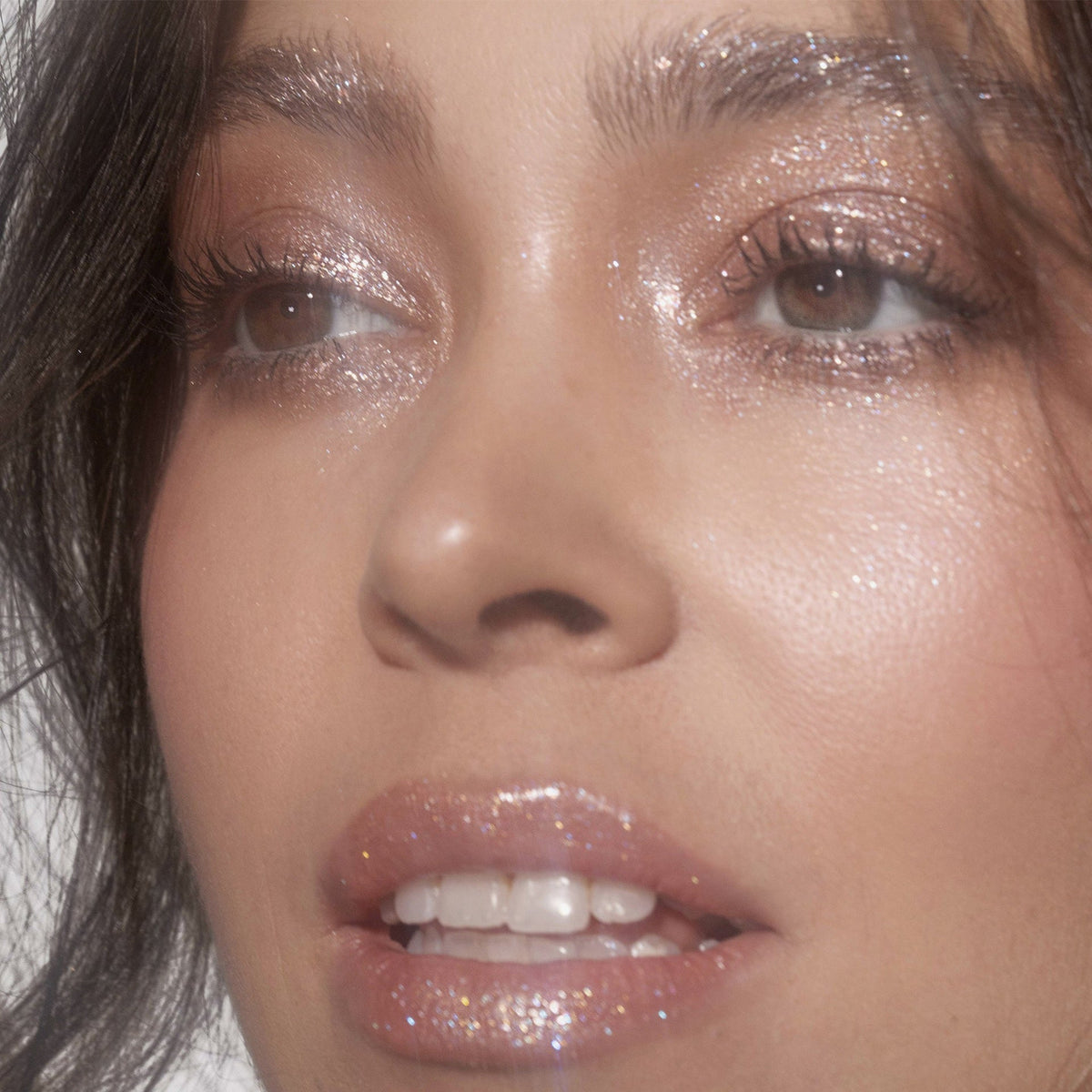 Nahaufnahme des Gesichts einer Frau mit rosa glitzerndem Lidschatten Sparkl Delish von LH Cosmetics.