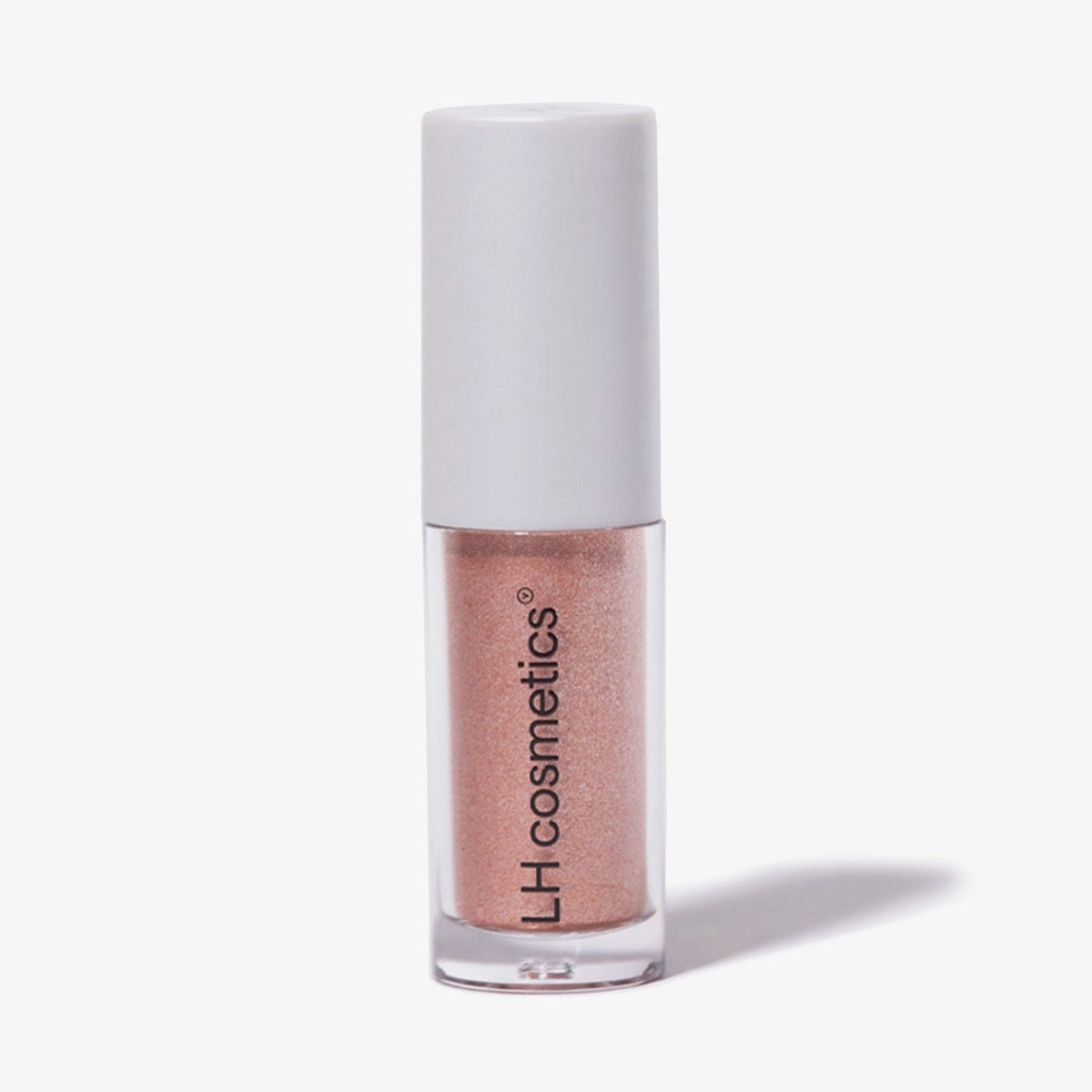 Transparente Tube Sparkl von LH Cosmetics mit weißer Kappe und pfirsich schimmerndem Farbton namens Flirt.