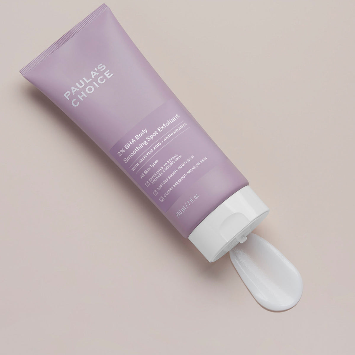 Eine Tube BHA Body Exfoliant mit herausgedrückter Creme auf hellem Hintergrund.