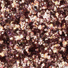 Nahaufnahme von funkelnden, metallischen Roségold/Bronze partikeln aus der Glorious Lights Glitter Palette, die zusammen gruppiert sind.