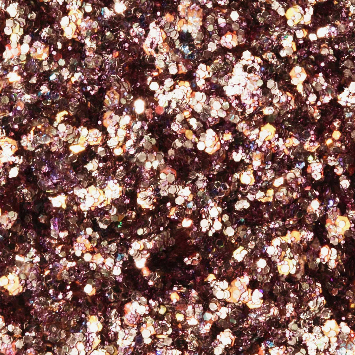 Nahaufnahme von funkelnden, metallischen Roségold/Bronze partikeln aus der Glorious Lights Glitter Palette, die zusammen gruppiert sind.