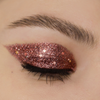 Geschlossene Augen mit kräftigem, roségoldenem Glitzerlidschatten aus der Miami Lights Glitter Palette.