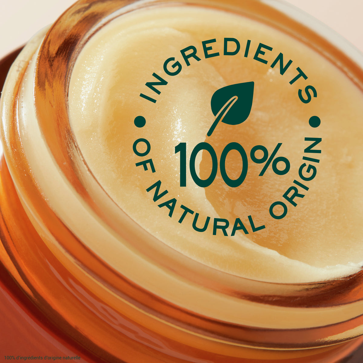 Nahaufnahme eines geöffneten Glastiegels mit cremigem Lip Balm. Auf dem Bild steht: 100 % Inhaltsstoffe natürlichen Ursprungs.