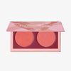 Geöffnete LH Cosmetics Duo Dimension Zone Palette mit einem pfirsichfarbenen und einem korallorangen schimmernden Farbton auf weißem Hintergrund.