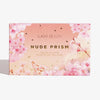 Die Box der Lunar Beauty Nude Prism Color Palette zeigt rosa Kirschblüten und goldene Akzente auf einem Hintergrund mit Farbverlauf.