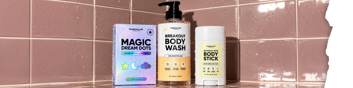 Drei Hautpflegeprodukte der Serie Breakout + Aid: Magic Dream Dots, Breakout Body Wash und Glycolic Acid Body Stick.