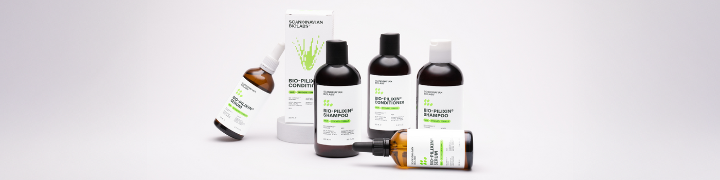 Fünf Haarpflegeprodukte von Scandinavian Biolabs, darunter Shampoo, Conditioner und Seren, auf weißem Hintergrund.