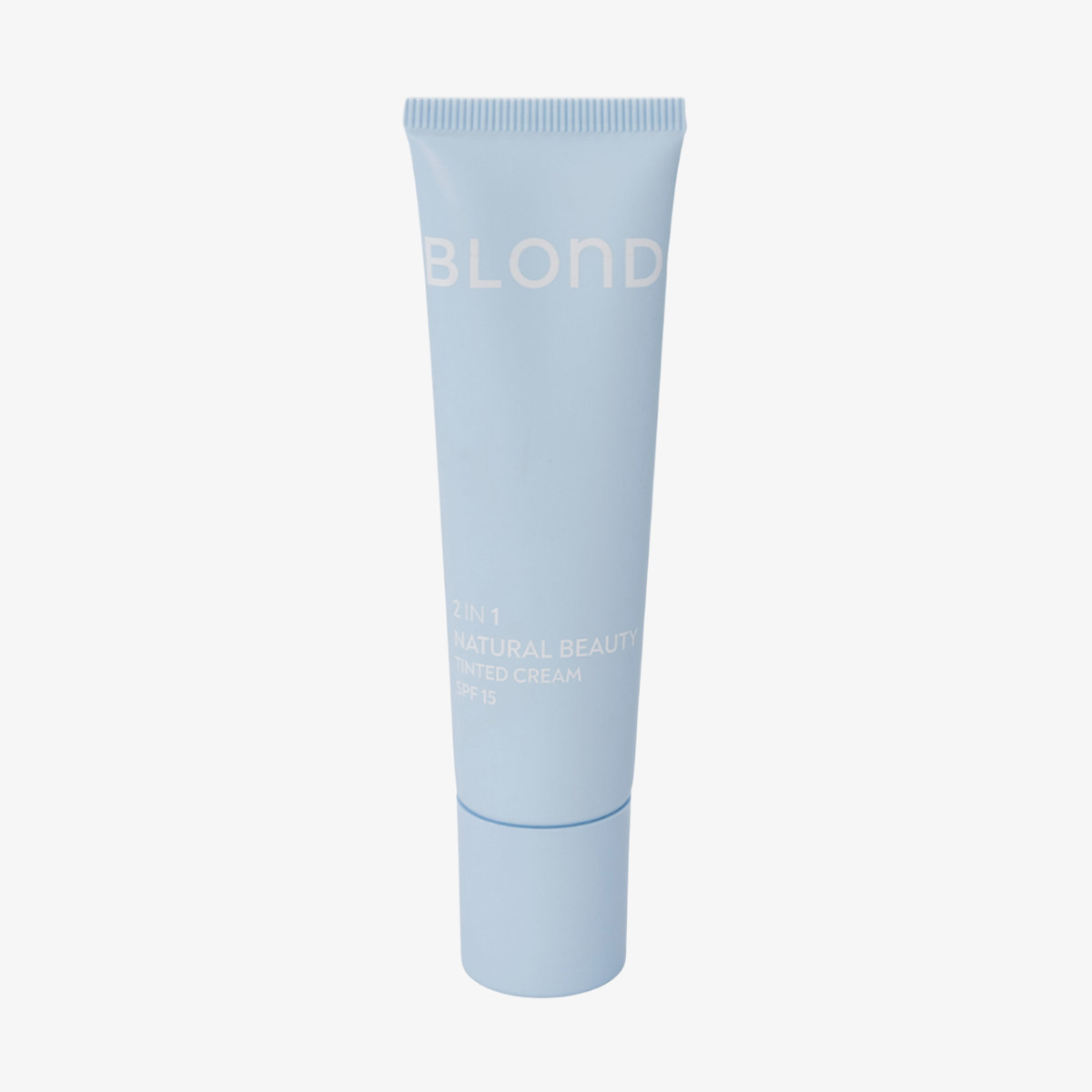 Eine blaue Tube mit der Aufschrift „BLONDESISTER 2 IN 1 NATURAL BEAUTY TINTED CREAM SPF15“ auf weißem Hintergrund.