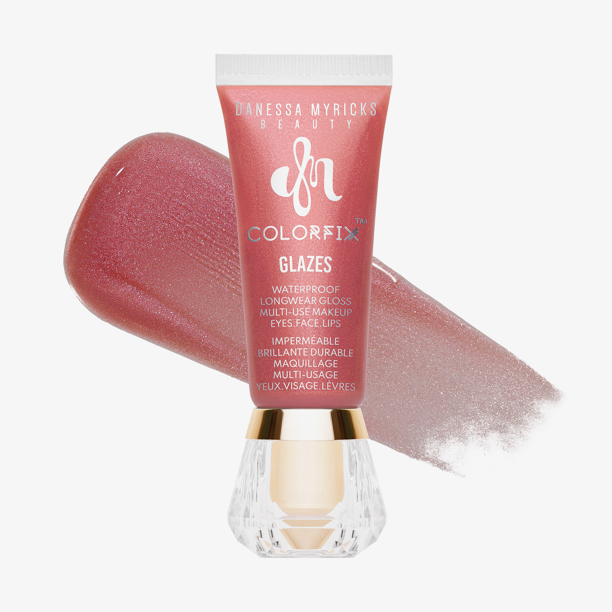 Danessa Myricks Beauty Colorfix Glaze in Pink Ice mit einem schimmernden rosafarbenen Muster hinter der Tube.