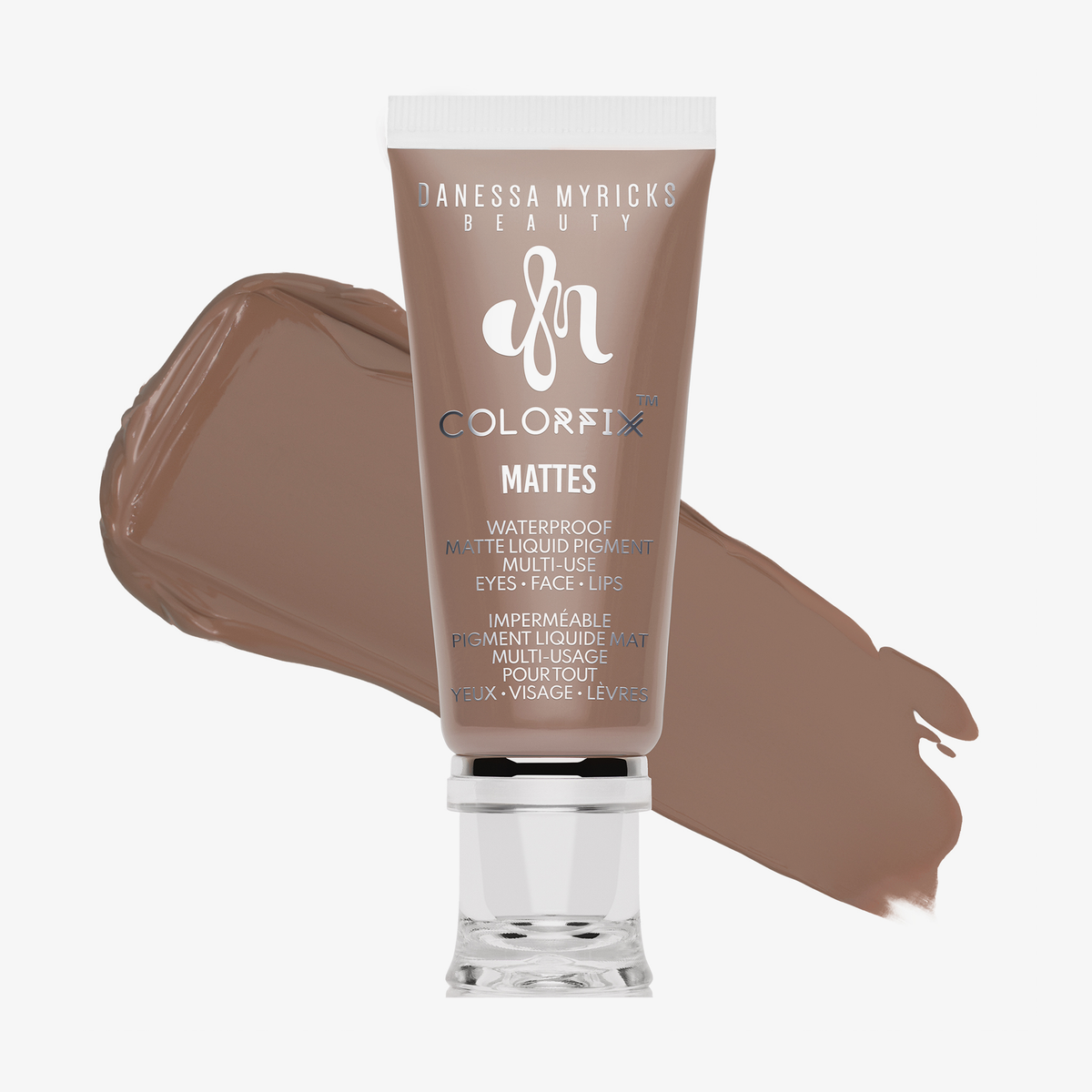 Eine Tube Danessa Myricks Beauty Colorfix Mattes in Exposed mit einem braunen Pigmentfleck im Hintergrund.