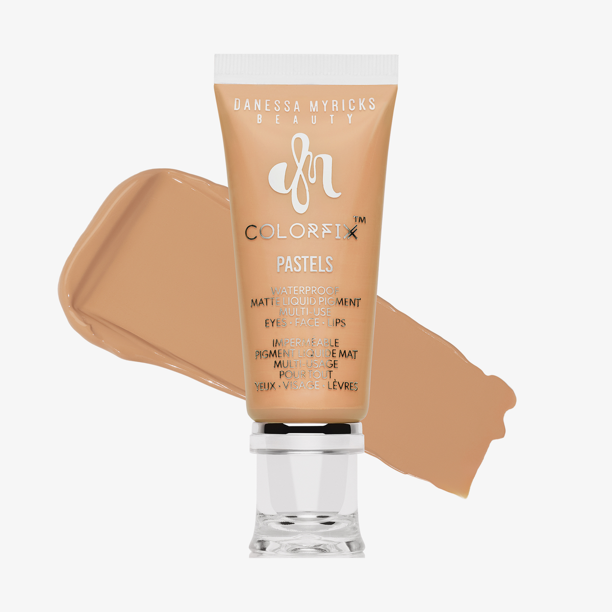Abgebildet ist eine Tube Danessa Myricks Beauty Colorfix Pastels Dreamsicle mit einem beigefarbenen Pigmentmuster dahinter.