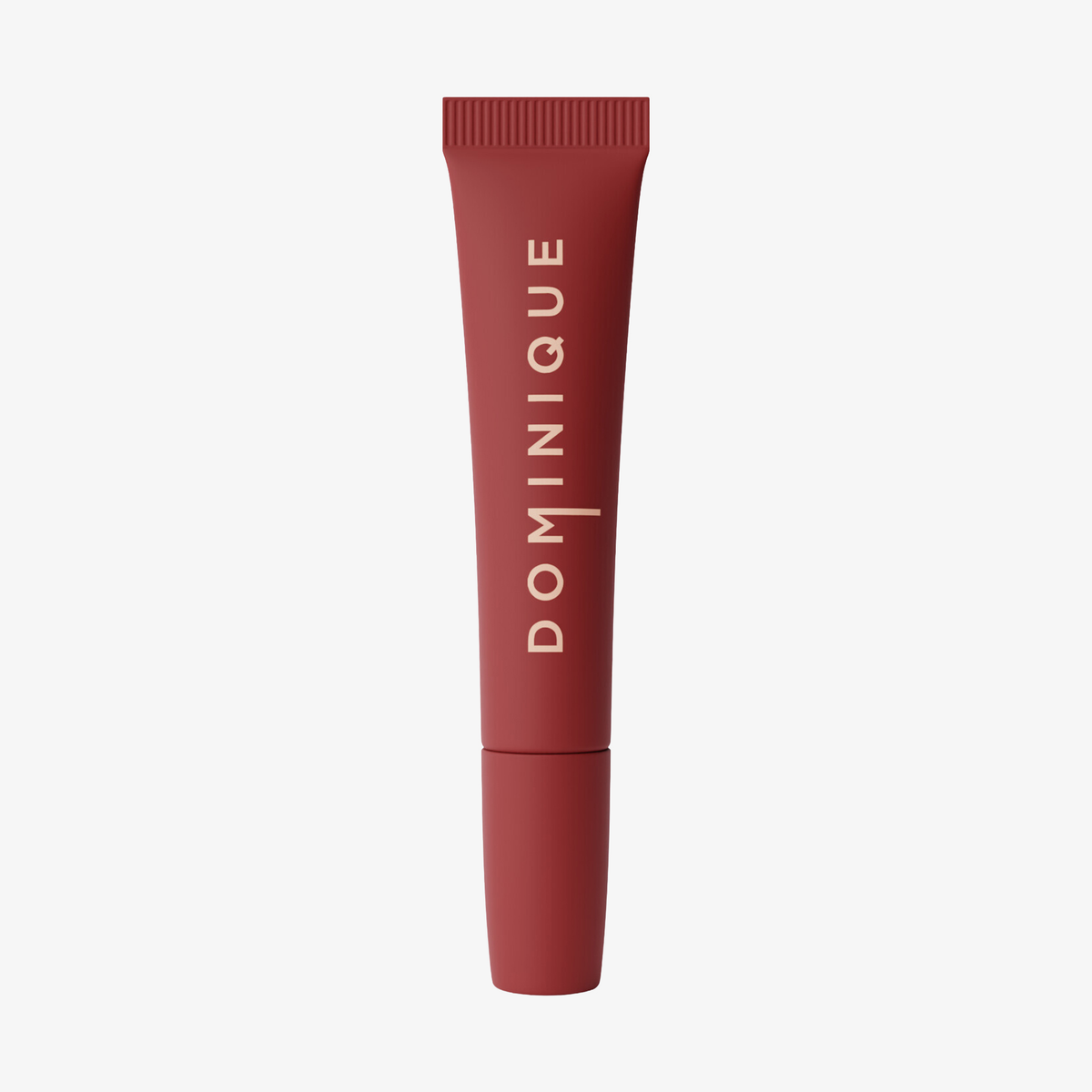 Eine rote Juicy Lip Balm Tube von Dominique Cosmetics mit vertikaler beiger Schrift auf weißem Hintergrund.