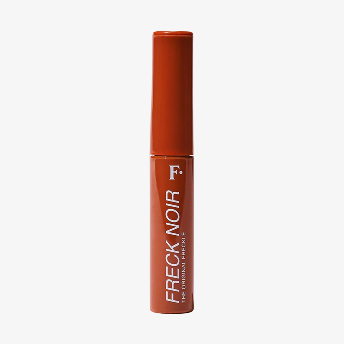 Eine rote Tube mit der Aufschrift Freck Noir von Freck Beauty steht vor einem schlichten weißen Hintergrund.