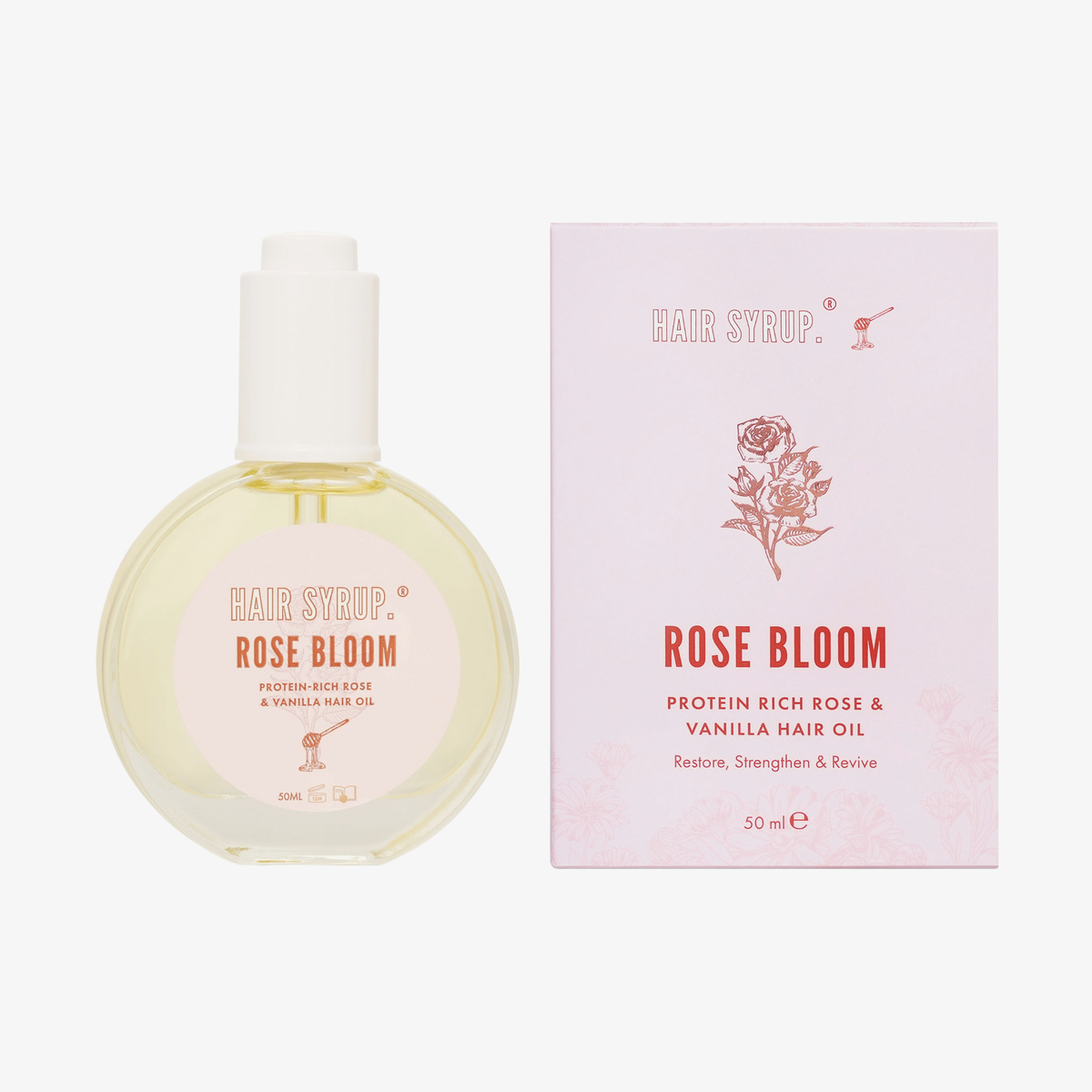Eine 50-ml-Flasche und eine Schachtel mit Rose Bloom von Hair Syrup, einem proteinreichen Haaröl mit Rose und Vanille.