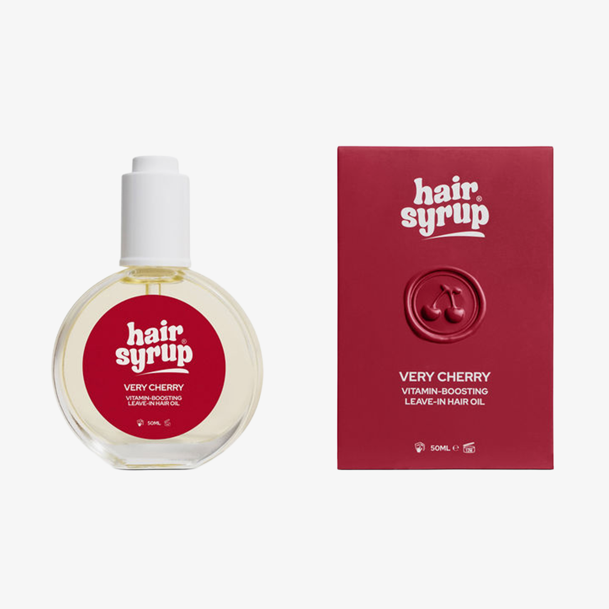 Eine runde Flasche und rote Schachtel Hair Syrup Very Cherry Leave-in Haaröl mit roten und weißen Etiketten.