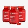 Drei Flaschen „HAIRtamin Gummy Stars™“ im 6-Monats-Paket, jeweils mit 60 veganen Gummibärchen, abgebildet mit zwei roten, sternförmigen Gummibärchen im Vordergrund.