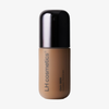 Eine Flasche der Foundation „Ctrl+ SKIN“ von LH Cosmetics mit schwarzem Verschluss und hellbrauner Flüssigkeit im Inneren.