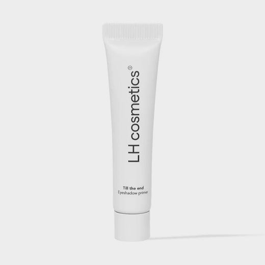 Eine weiße Tube mit der Aufschrift "LH Cosmetics Till The End Eyeshadow Primer" wird vor einem schlichten hellen Hintergrund gezeigt.