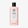 Eine rosa Flasche „Maria Nila Mirror Gloss Conditioner“ mit einem weißen Etikett und schwarzer Schrift.