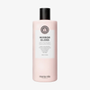 Eine rosa Flasche des Maria Nila Mirror Gloss Shampoos mit schwarzem Verschluss und einem Etikett auf der Vorderseite.