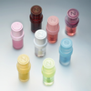 Acht pastellfarbene „Lip Candy Oil“-Tuben von NABLA Cosmetics, jeweils mit einem N-Logo, angeordnet auf einer weißen Fläche.