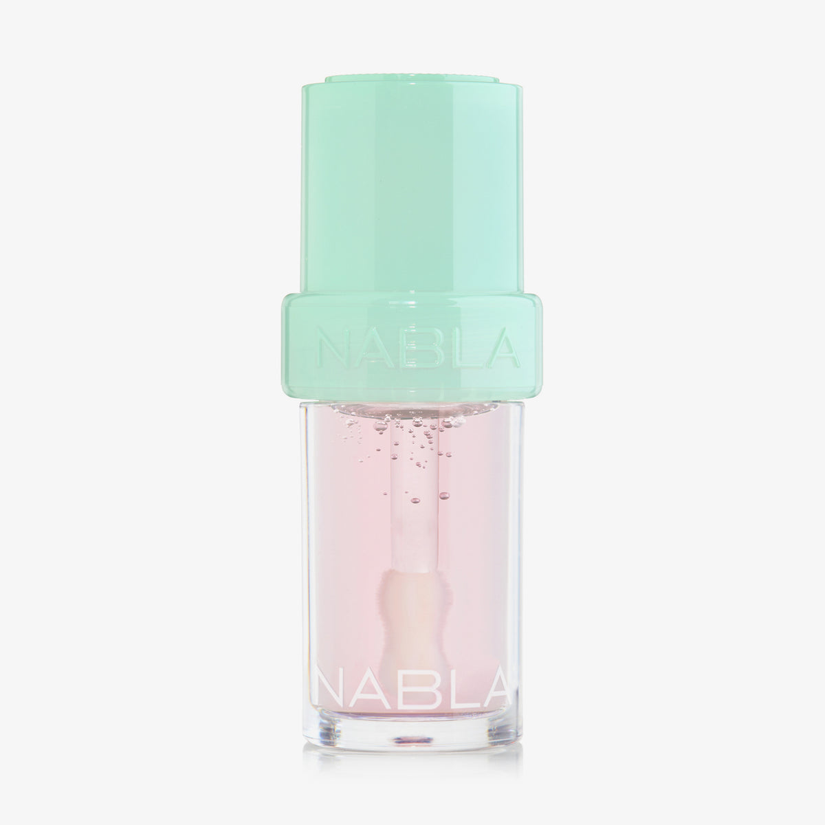 Lip Candy Oil in Watermelon von NABLA in transparenter Verpackung mit mintgrünem Deckel und glänzender leicht rosaner Textur.