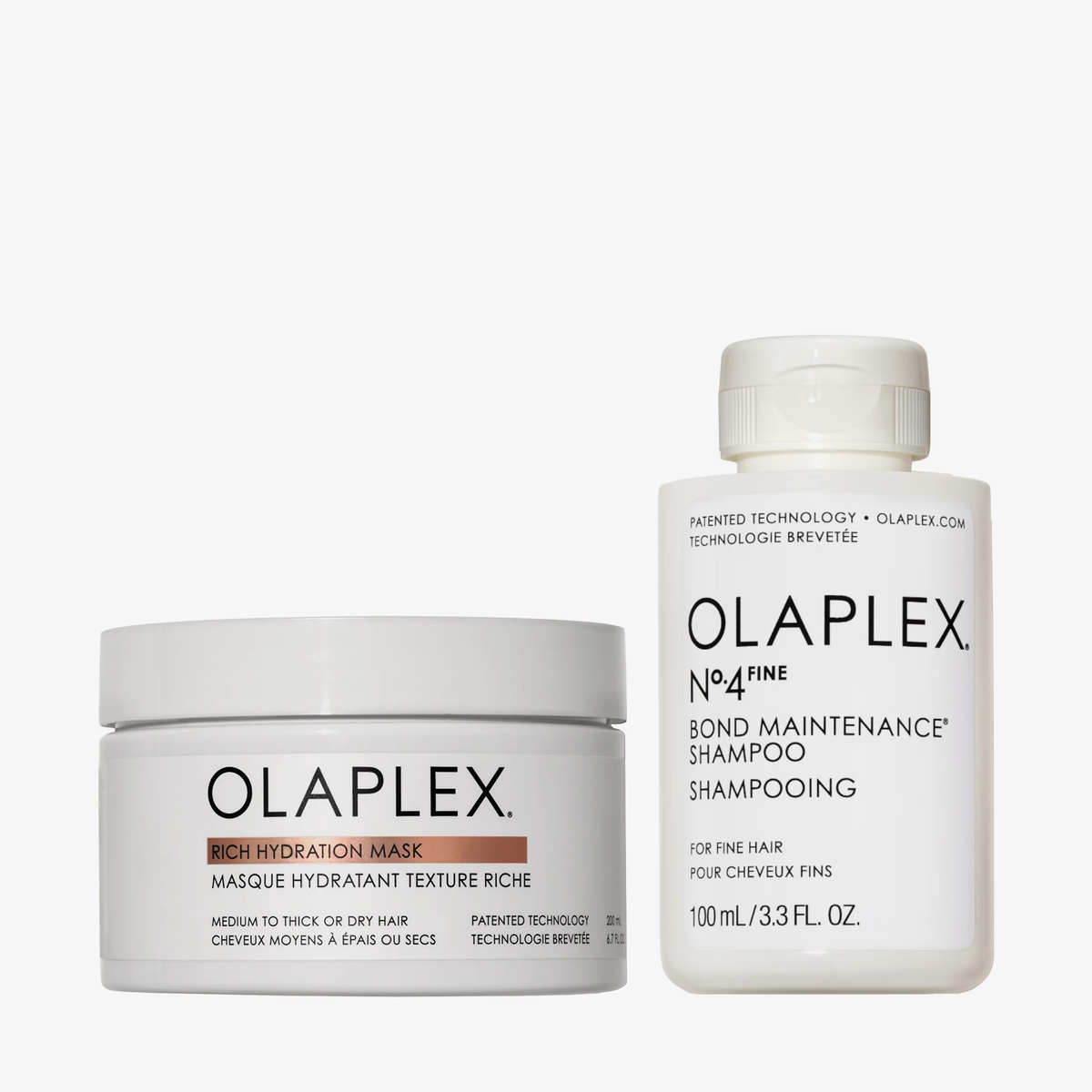 Das OLAPLEX Hydration Heroes-Weihnachtsset 2026 enthält einen weißen Tiegel mit einer intensiv feuchtigkeitsspendenden Maske und eine weiße Flasche mit einem Shampoo zur Pflege der Haarverbindungen.