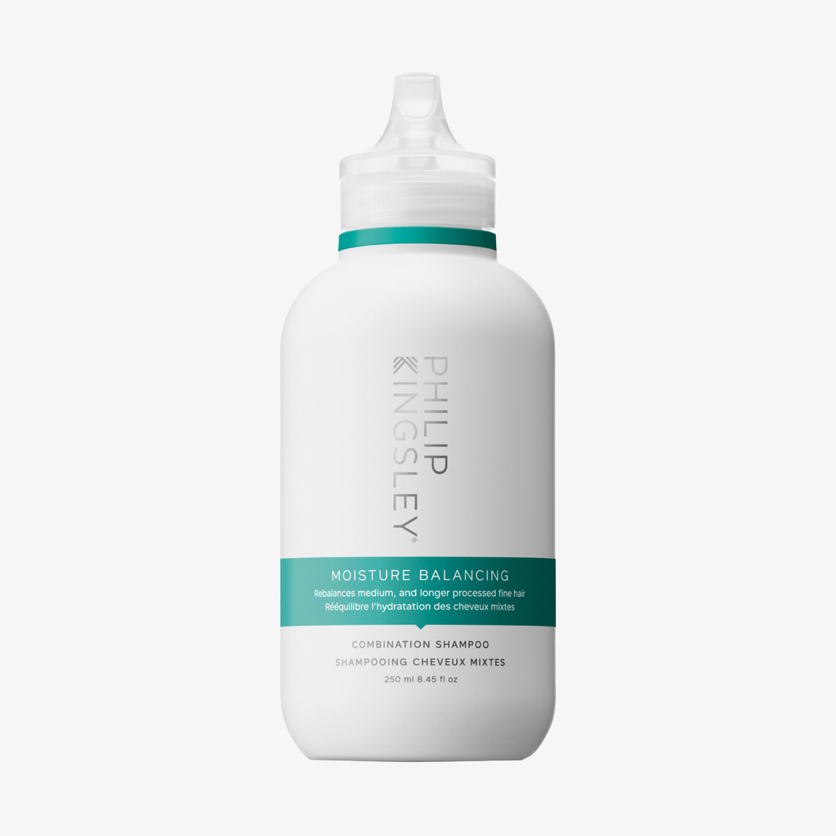 Eine weiße Flasche „Philip Kingsley Moisture Balancing Shampoo“ mit einem türkisfarbenen Etikett und einem Klappverschluss.