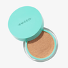 In einem türkisfarbenen SWEED-Behälter befindet sich „Miracle Powder“, eine lose, beigefarbene Grundierung; der Deckel ist teilweise geöffnet.