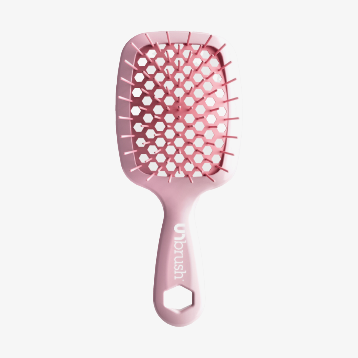 Eine rosafarbene Detangling Hair Brush Mini von UNbrush mit einem wabenförmigen, belüfteten Paddel und dem Markennamen auf dem Griff.